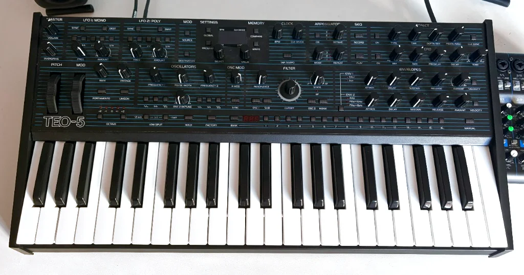 An Oberheim TEO-5 synthesizer with two iLoud Micro Monitors and a Yamaha MG06X mixer